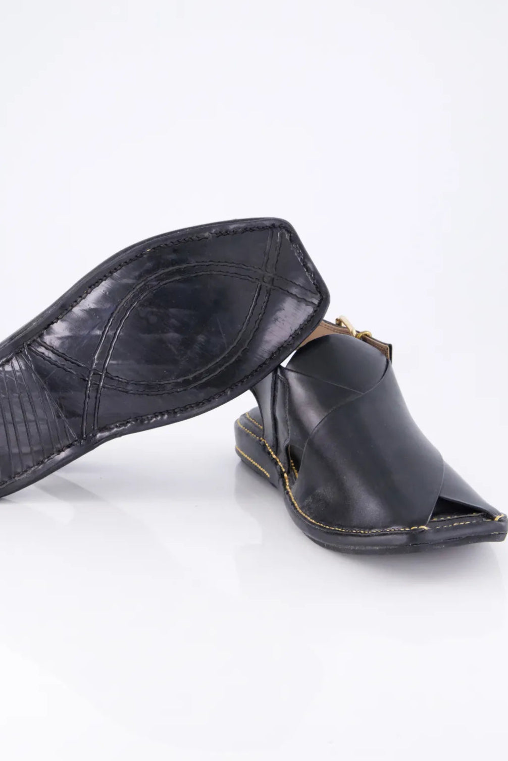 Black leather sandal with open toe on a white background