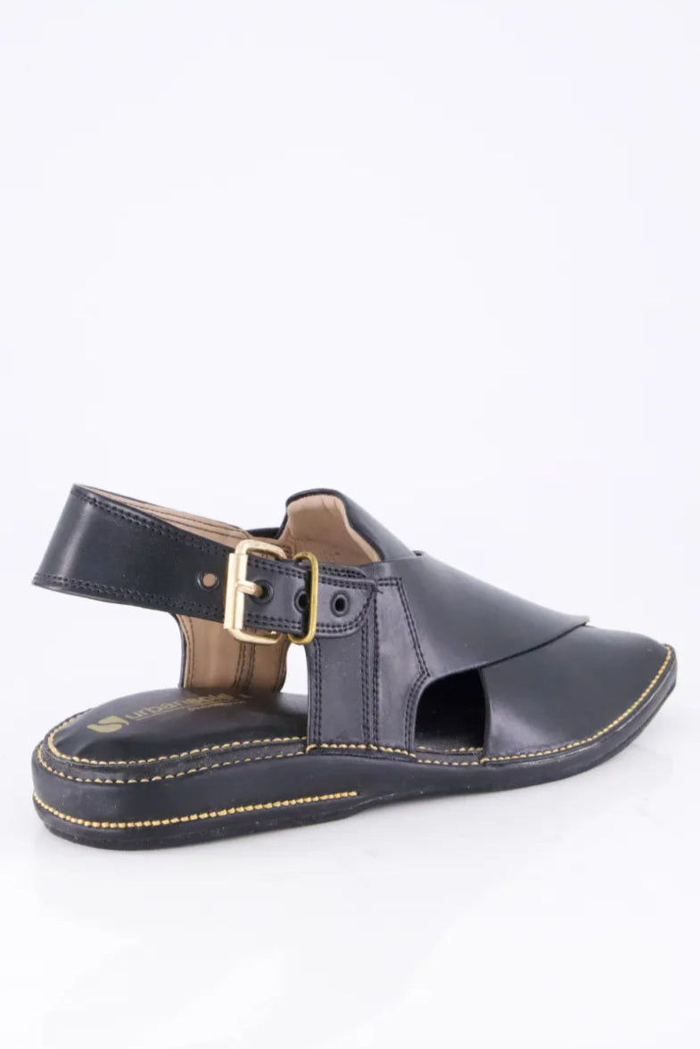 Black sandal with a gold buckle on a white background