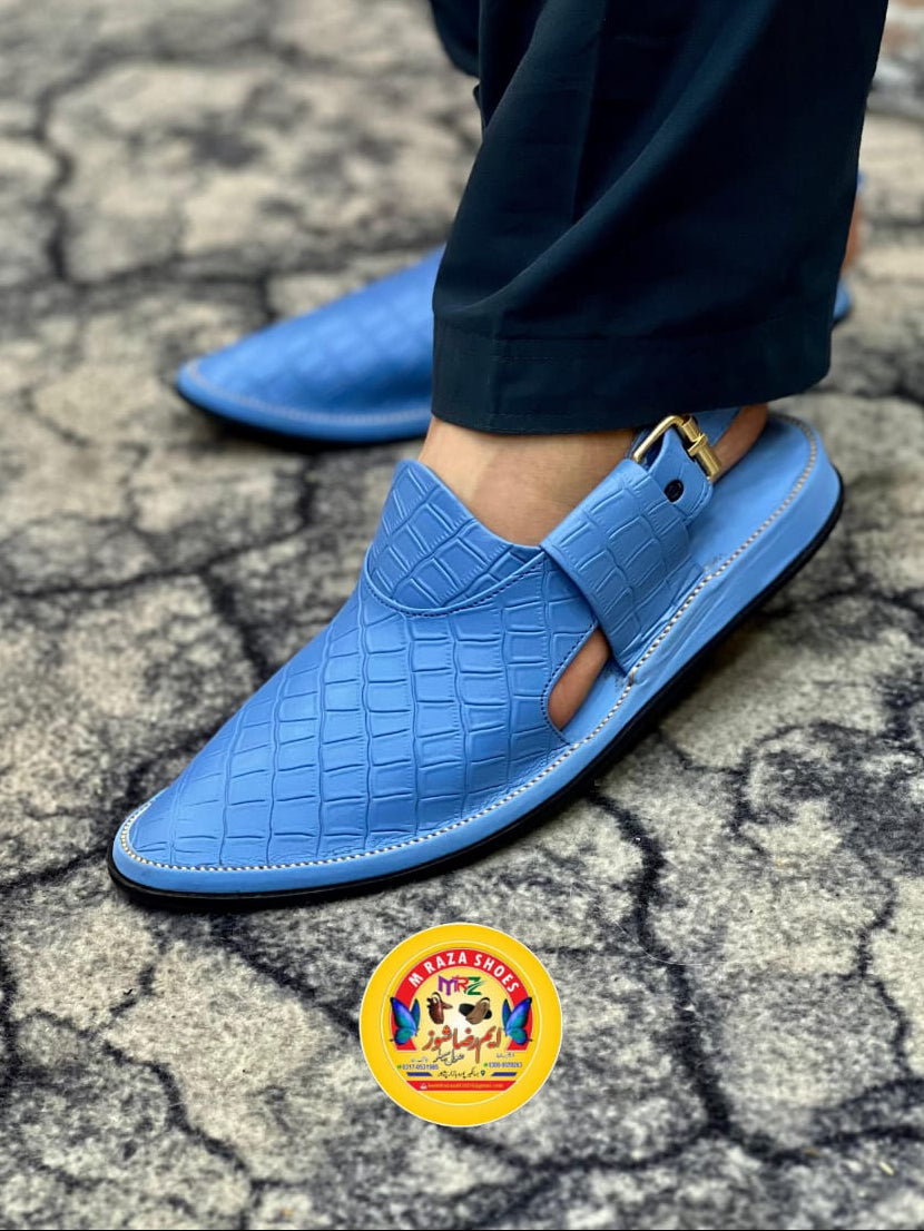 Blue sandals being worn on a cracked ground surface with a price tag of Rs3500 displayed.