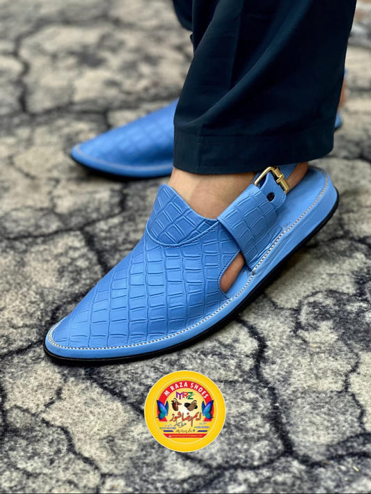 Blue sandals being worn on a cracked ground surface with a price tag of Rs3500 displayed.