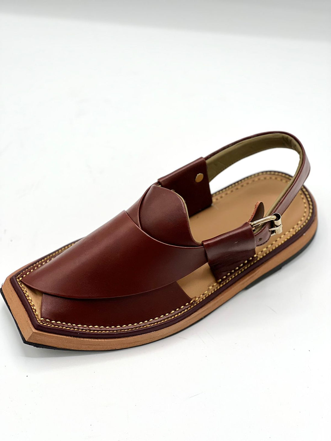 Brown sandal with a strap on a white background